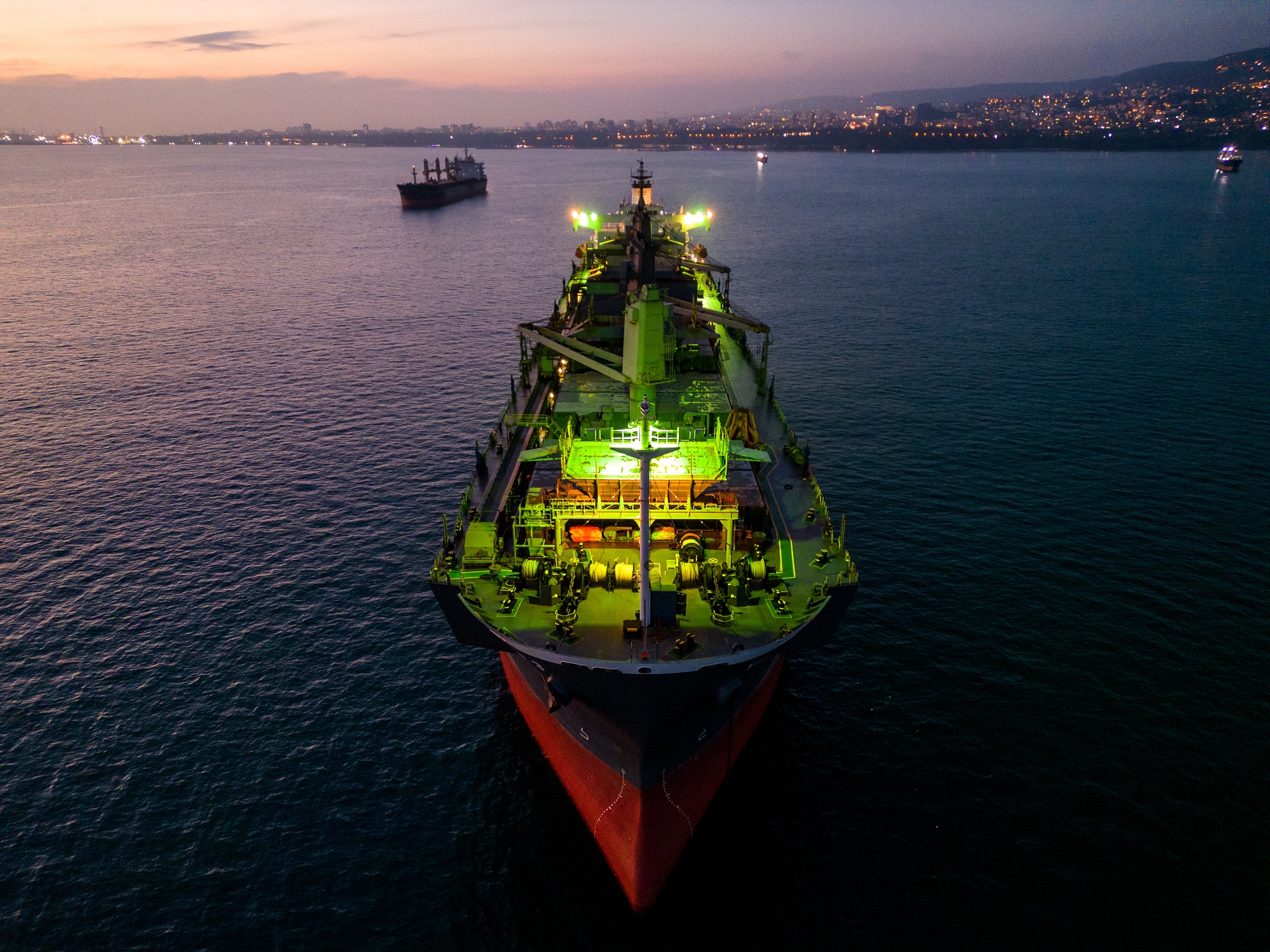 A massive cargo ship wood chips carrier in the sea, aerial view.